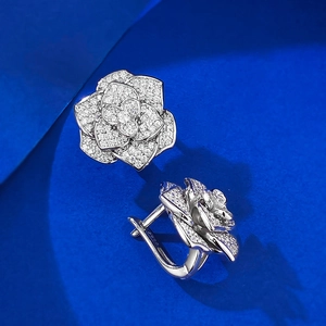 Macro detail of S925 silver camellia earrings with pavé set cubic zirconia petals