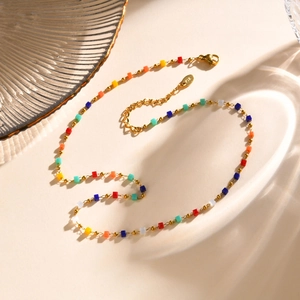 Detail of 18K gold stainless steel chain with colorful rectangular beads and K18 tag
