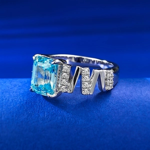 Macro shot of rectangular aquamarine stone and geometric M-shaped silver ring band