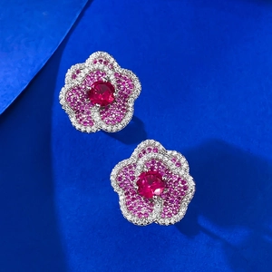 Classic floral stud earrings with round ruby-red center stone and sparkling zircon halo