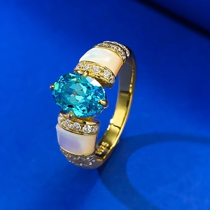 Macro detail of S925 silver ring with oval paraiba blue stone and shell inlay