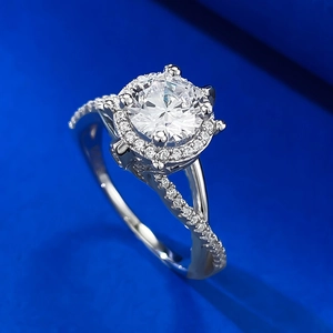 Macro shot of a 925 silver ring with a halo diamond and criss-cross pave band