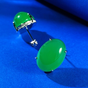 Macro detail of 925 silver stud earrings with oval green chalcedony and micro pavé crystals