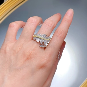 Detailed close-up of 925 sterling silver leaf ring with full pavé diamonds on finger