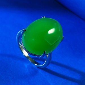 Macro view of 925 silver ring featuring a large green oval chalcedony with zircon accents