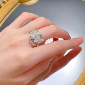 Macro view of silver leaf ring with gold accents and sparkling cubic zirconia stones