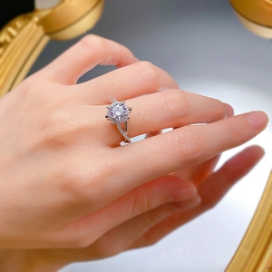 Macro shot of 1 carat round diamond ring with halo setting and twisted pave band