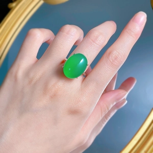Elegant 925 silver plated ring with a large oval green agate stone on a blue background