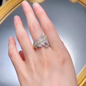 Close-up of 925 sterling silver leaf ring with pavé diamonds and yellow gemstones