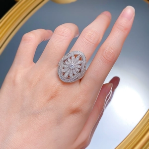 Luxurious silver flower ring featuring white zircon stones shown on a model's hand
