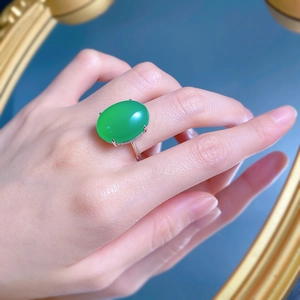 Close-up of model wearing 925 silver plated ring with large oval green chalcedony stone