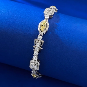 Detail of silver bracelet featuring yellow marquise-cut stone and sparkling white zircons