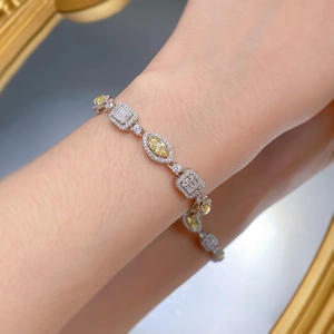 Macro shot of a 925 silver bracelet with marquise yellow stones worn on a woman's wrist