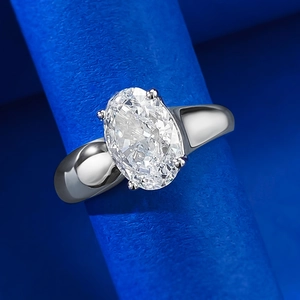Macro detail of oval ice-cut sparkling gemstone ring with polished silver-tone wide band