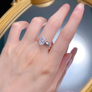 Detail of S925 silver oval ice flower cut ring worn on finger in minimalist style