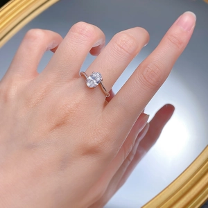 Detail of S925 silver oval cut diamond ring featuring an elegant bypass shank design