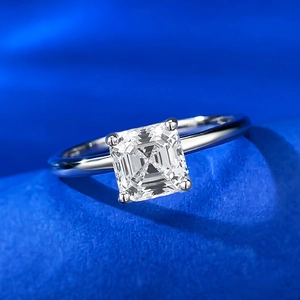 Macro view of a square-cut diamond ring on a vibrant blue velvet surface detail