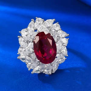 Luxurious flower ring with large oval red pigeon blood stone and marquise diamond halo