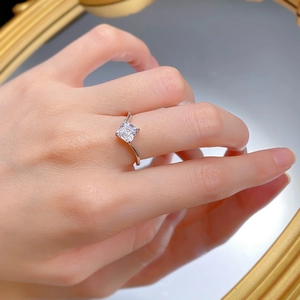 Macro shot of 925 sterling silver ring with princess cut cubic zirconia on a mirror