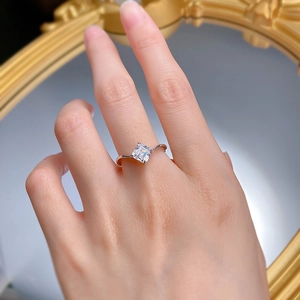 Macro shot of S925 sterling silver ring with princess cut diamond on hand