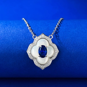 Macro shot of S925 silver flower pendant with blue sapphire and white mother of pearl