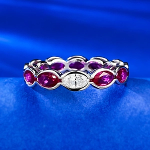 Macro shot of S925 silver ring featuring oval-cut diamonds and red purple gemstones