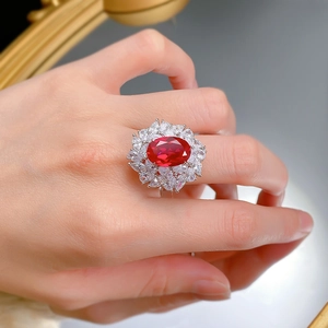 Close-up of S925 silver ring with 9x13mm red oval gemstone and marquise zirconia halo