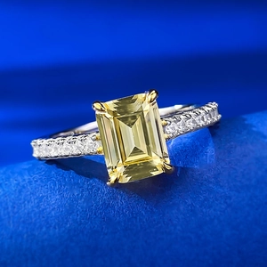 Macro shot of 1.5 carat emerald cut yellow sapphire ring with a diamond-encrusted band