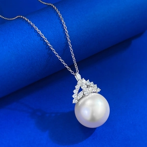Macro shot of 16mm white pearl necklace pendant with sparkling silver crown setting