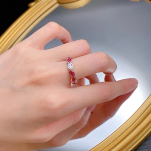 Detail of vintage S925 silver ring with red oval stones and marquise cut crystal