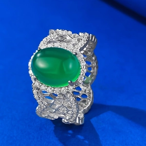 Detail of vintage silver ring with green agate centerpiece and hollow filigree design