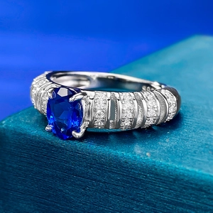 Macro shot of S925 silver ring featuring oval sapphire and diamond-encrusted ridges
