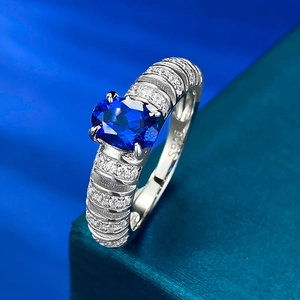 Elegant S925 silver ring featuring an oval blue sapphire and pavé crystal band