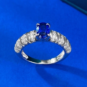 Elegant S925 sterling silver ring with oval blue sapphire and side stones on blue background