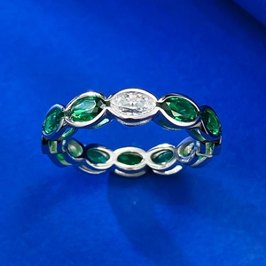 Close-up of S925 silver ring with oval white stone and marquise green emerald accents