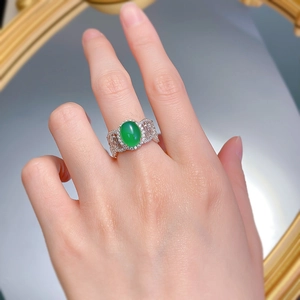 Close-up of a silver ring featuring a large green chalcedony stone and pavé details