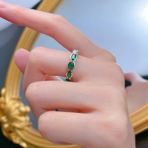 Detail of S925 silver eternity ring featuring green marquise stones and clear accents