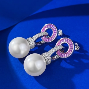 Detail of S925 silver earrings with 14mm white pearls and pink cubic zirconia accents