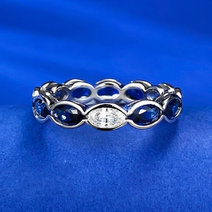 Macro detail of S925 silver ring featuring blue oval and clear marquise cut cubic zirconia