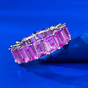 Macro view of 925 silver eternity band with rectangular pink stones in claw setting
