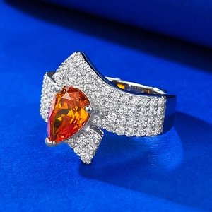 Elegant 925 silver ring featuring a 2-carat pear-cut orange stone and micro-pave diamonds