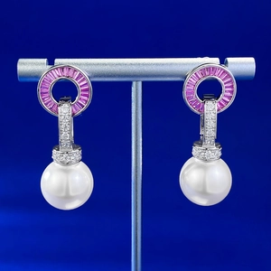 Detail view of S925 silver earrings with 14mm pearls and pink stepped gemstones