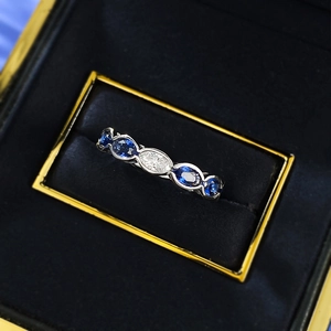 Close-up of S925 silver oval blue and white diamond ring in a luxury velvet box