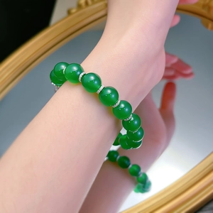 Macro shot of green chalcedony beaded bracelet with silver diamond-set spacers on wrist