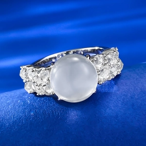 Macro shot of 925 silver ring featuring a large translucent jadeite egg and side zircons