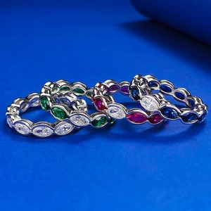 Close-up of S925 silver eternity rings with marquise-cut green, red, and blue gemstones