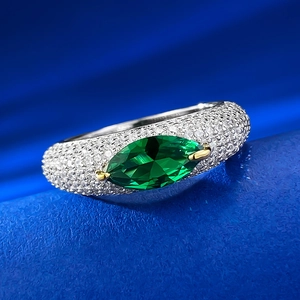 Macro detail of S925 silver ring featuring marquise green gemstone and pavé diamonds