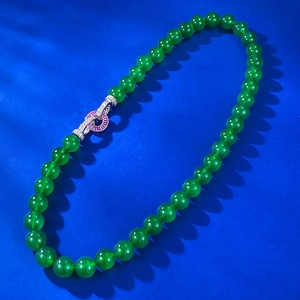 Green chalcedony bead necklace with a 925 silver gemstone clasp on blue background