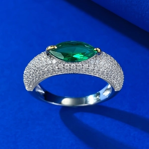 Macro shot of S925 silver ring featuring a green marquise gemstone and pavé diamonds