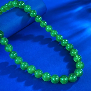 Detailed view of 10.0mm green chalcedony beaded necklace with polished gemstone luster